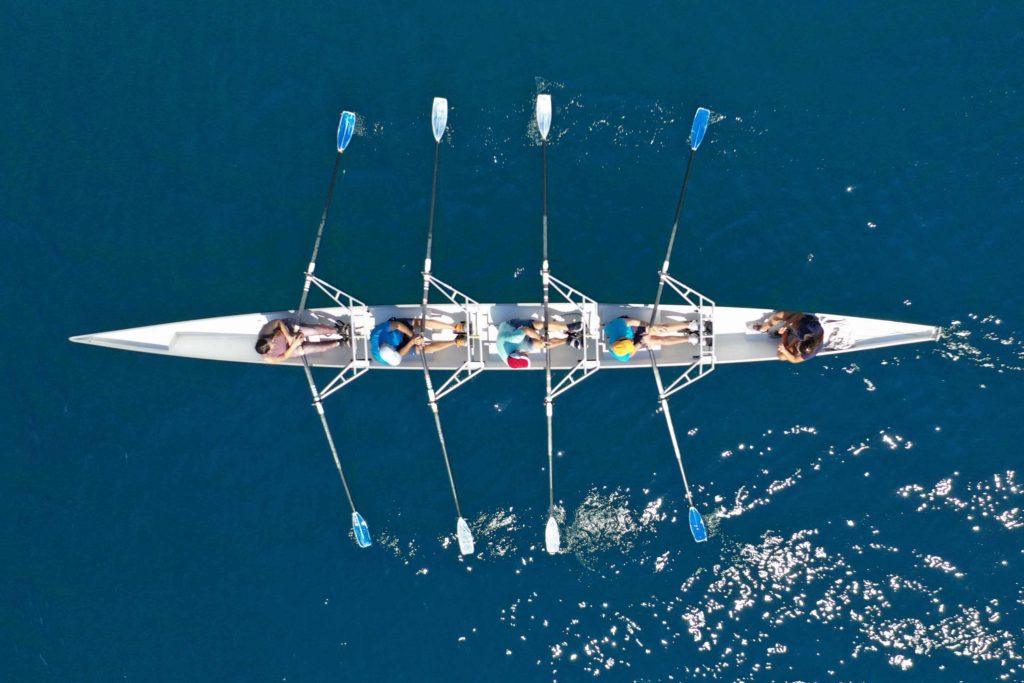 rowers in a boat used to illustrate the concept of shareholder and partnership agreements